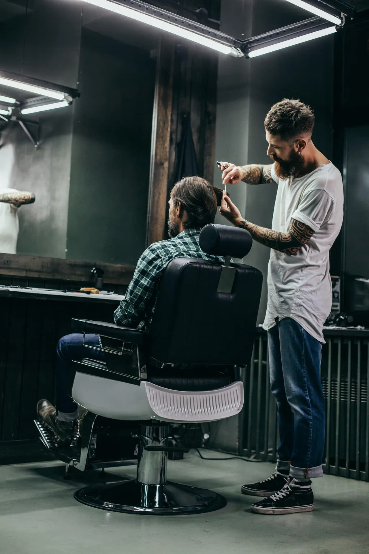 Barber applying hair treatment to a client